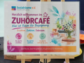 Veranstaltungsfoto vom ersten Erzähl- und Zuhörcafé von Sozialräume e.V. am 4. Oktober 2026 im Städtischen Familienzentrum Kaarst-Mitte in der Büdericher Straße. Zu sehen ist die Willkommenstafel des Zuhörcafés mit dem Leitgedanken „Erzählen. Zuhören. Dabeisein.“ sowie ein Teil des vorbereiteten Cafébereichs.